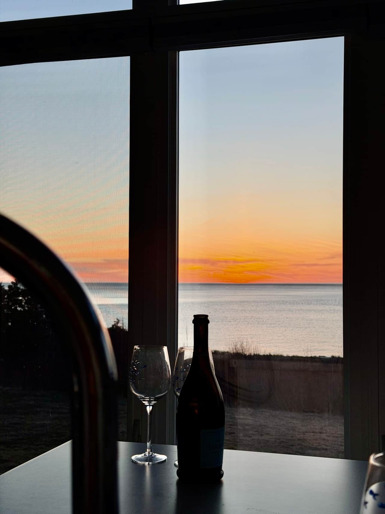 Sip some wine when the sun goes down by the ocean. 