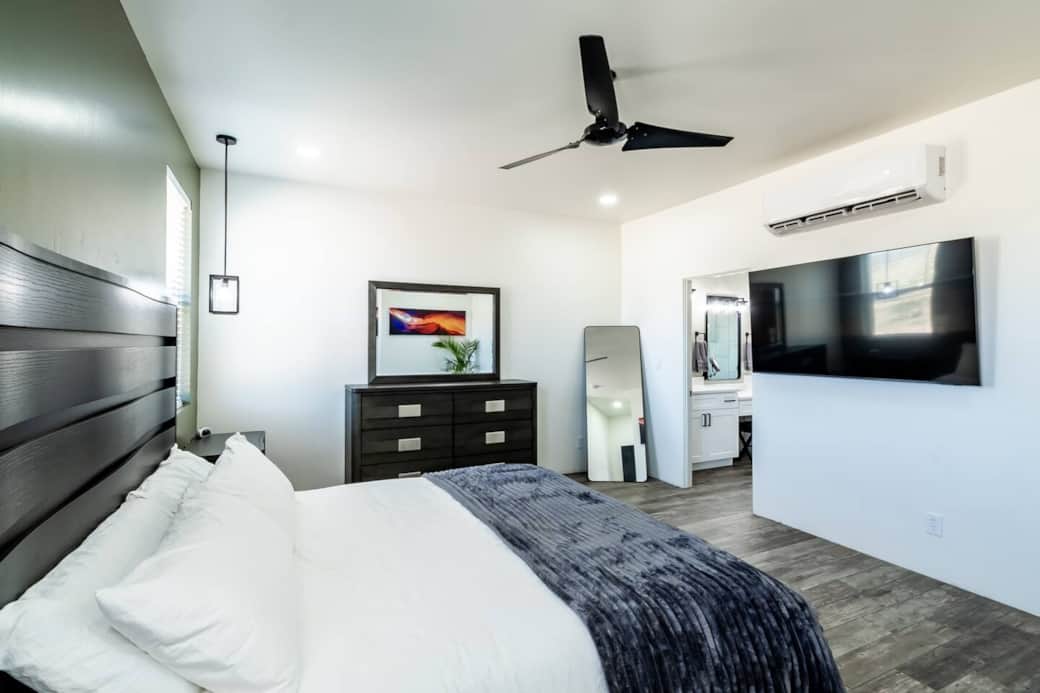  Relax on the luxurious king-size bed with plush bedding in the spacious master bedroom, complete with a 65-inch TV for your entertainment.