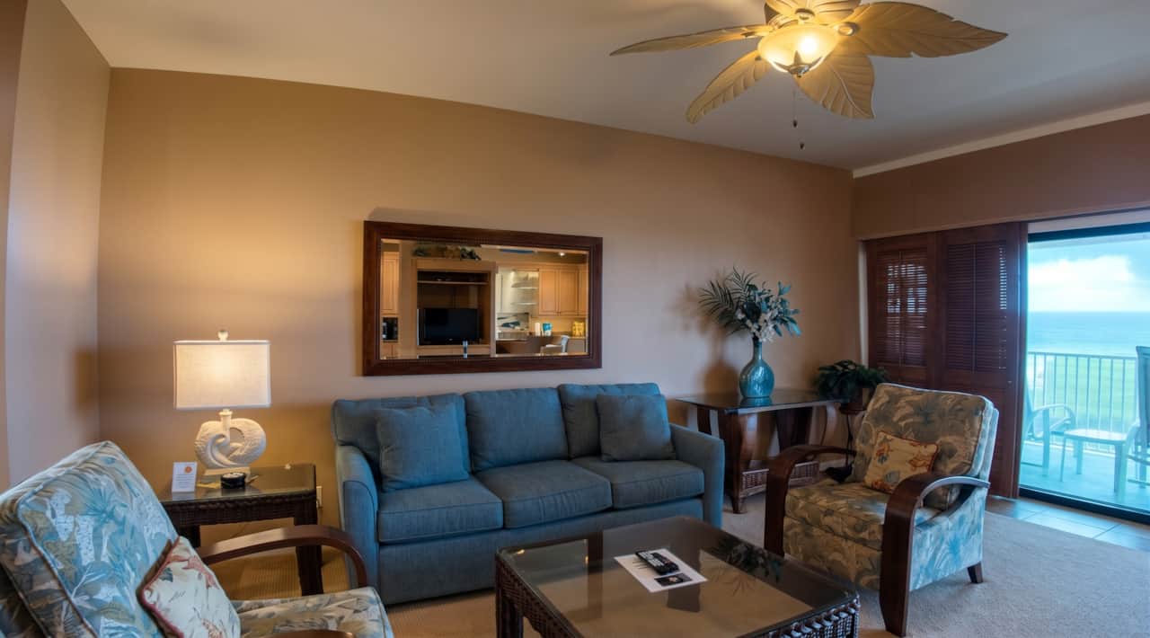 Inviting living room with comfortable seating and ocean views just beyond the lanai.