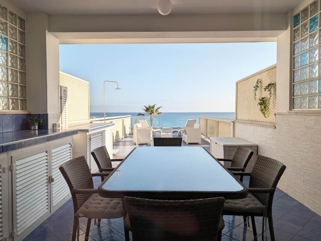 Covered outdoor dining space with sea view