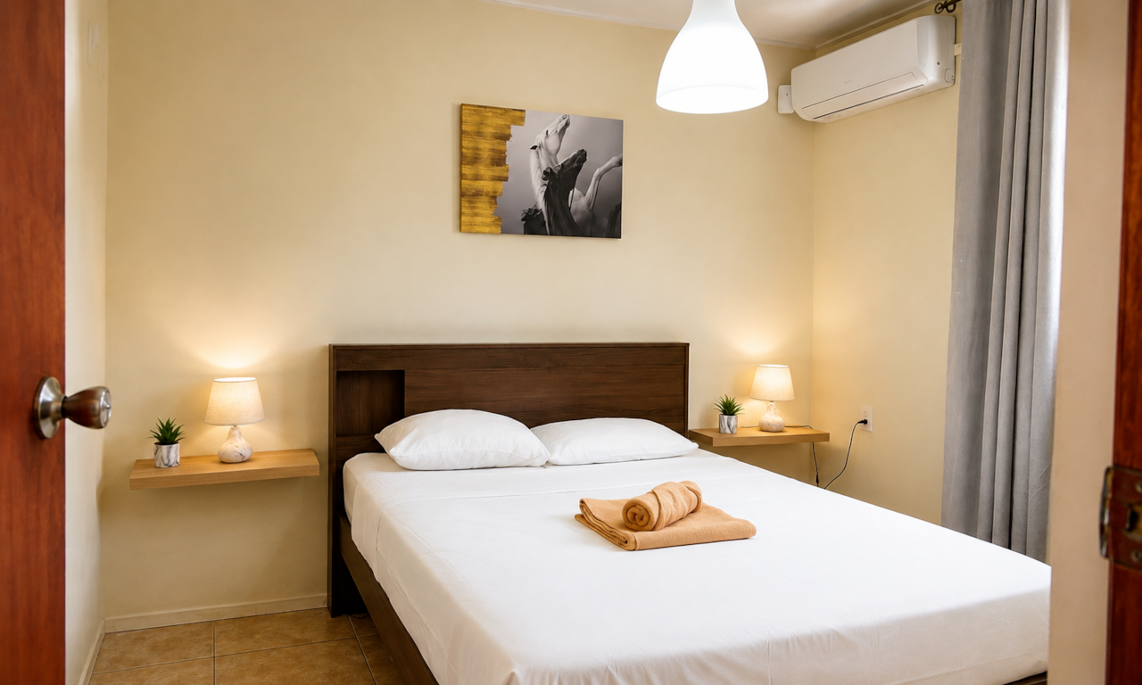 Master bedroom with double bed, air conditioning and spacious wardrobe.