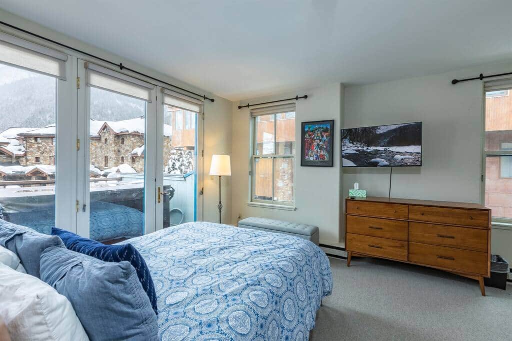 Prime corner bedroom with mountain views and direct access to balcony. 