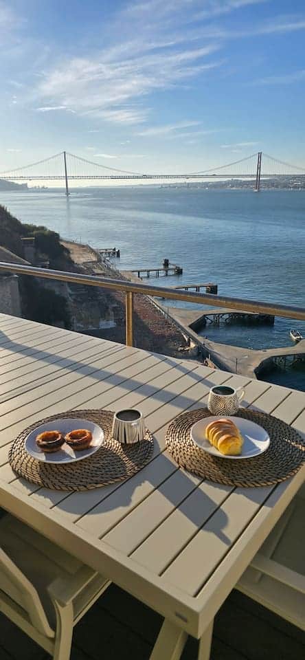 A perfect vertical shot for mobile, showing breakfast with the full bridge view.