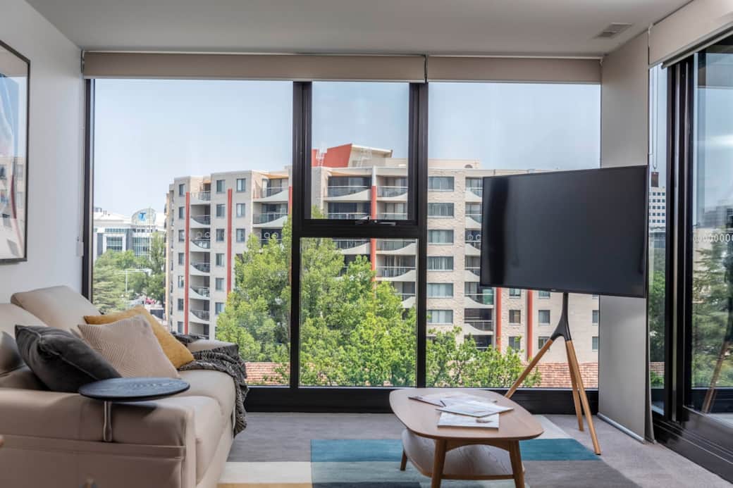 Snuggle up and relax on your  lounge with adjustable headrests and enjoy the views, read about what’s happening or watch a movie on TV.The contemporary design, with its clean lines and neutral palette, is complemented by the vibrant city view. 