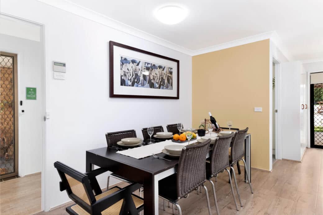 The dining area shares the same room as the kitchen. The dining room table seats eight.