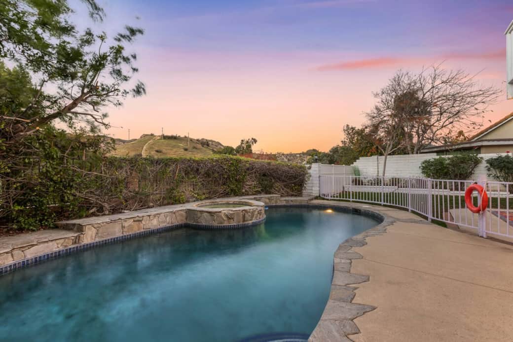 Soak in the hot tub with stunning sunset views over the hills.