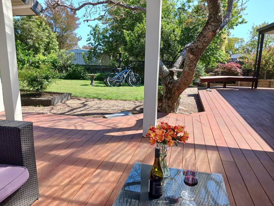 Alfresco decking wraps around to front sliding glass door.