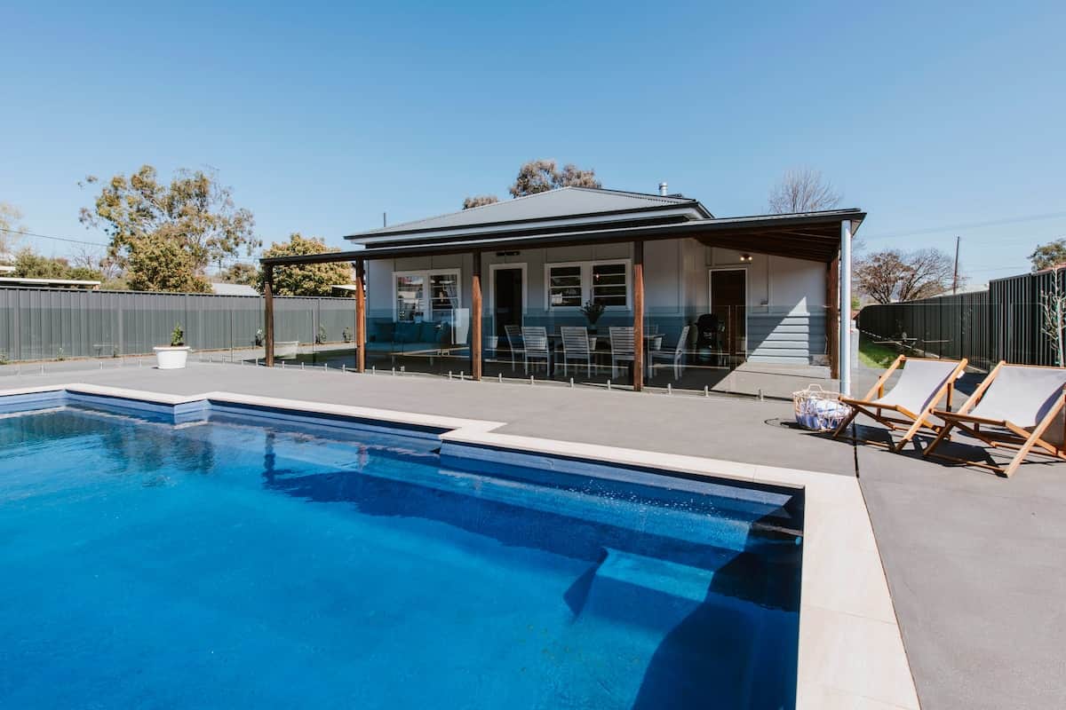 A sparkling, solar-heated pool awaits in your very own private oasis, offering the perfect spot to relax and unwind.