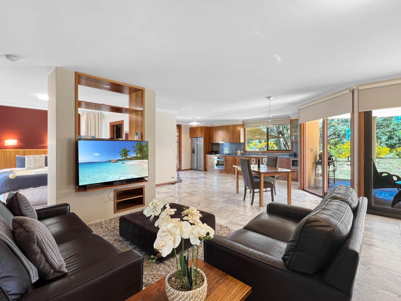 Experience spacious living with a smart TV and glass wall for indoor comfort and stunning views.