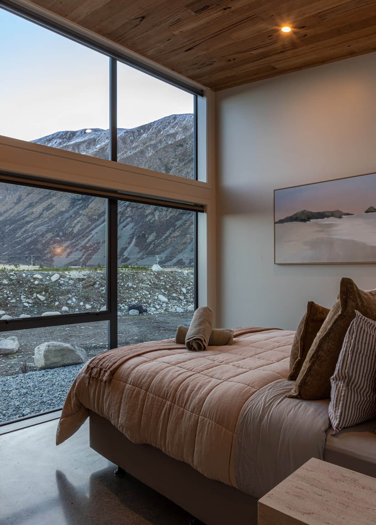 Bedroom 1 with king bed and floor to ceiling windows to take in the views of the Mackenzie region