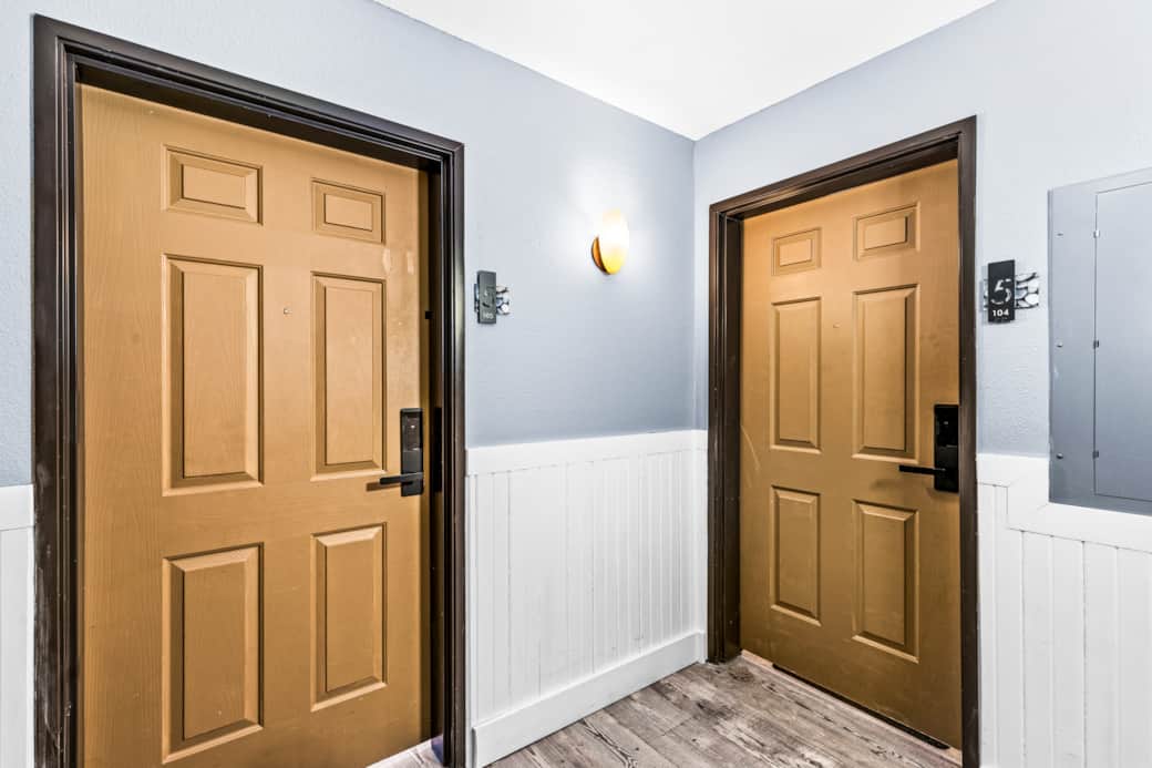 Elegant entrance doors leading to cozy, private bedrooms