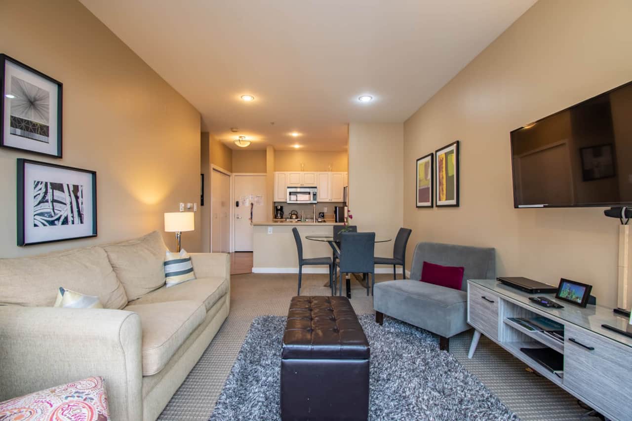 Spacious living room with flatscreen TV And beautiful courtyard garden views