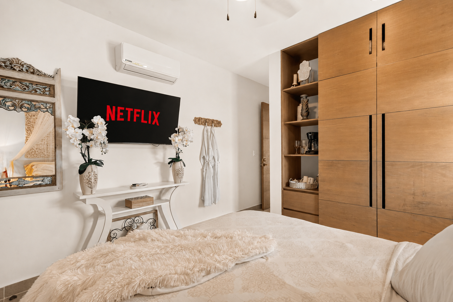 Private bedroom with Smart TV, ensuite bath, bathrobes, AC, and a relaxing tropical feel.
