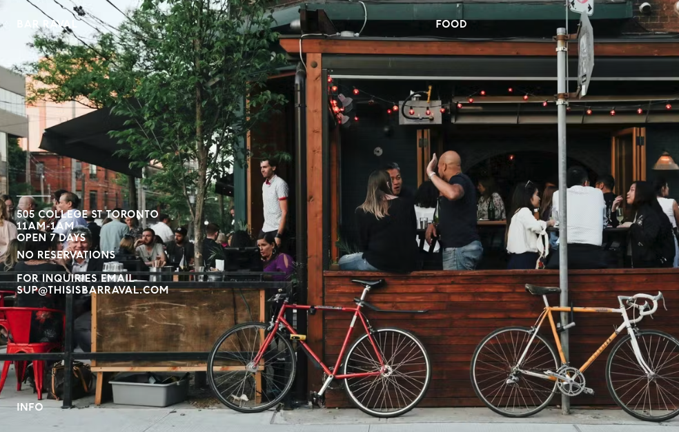 Exterior view of Bar Raval, a notable restaurant in Toronto, situated conveniently close to Posh Digs homes. This image captures the inviting ambiance of the restaurant, highlighting its appeal to guests staying in the nearby short-term rentals.