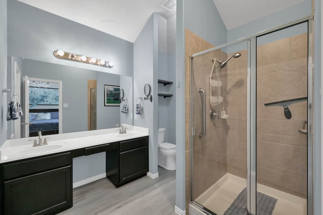 Accessible bathroom with grab bars in the shower and in the toilet area Accessible bathroom with grab bars in the shower and in the toilet area