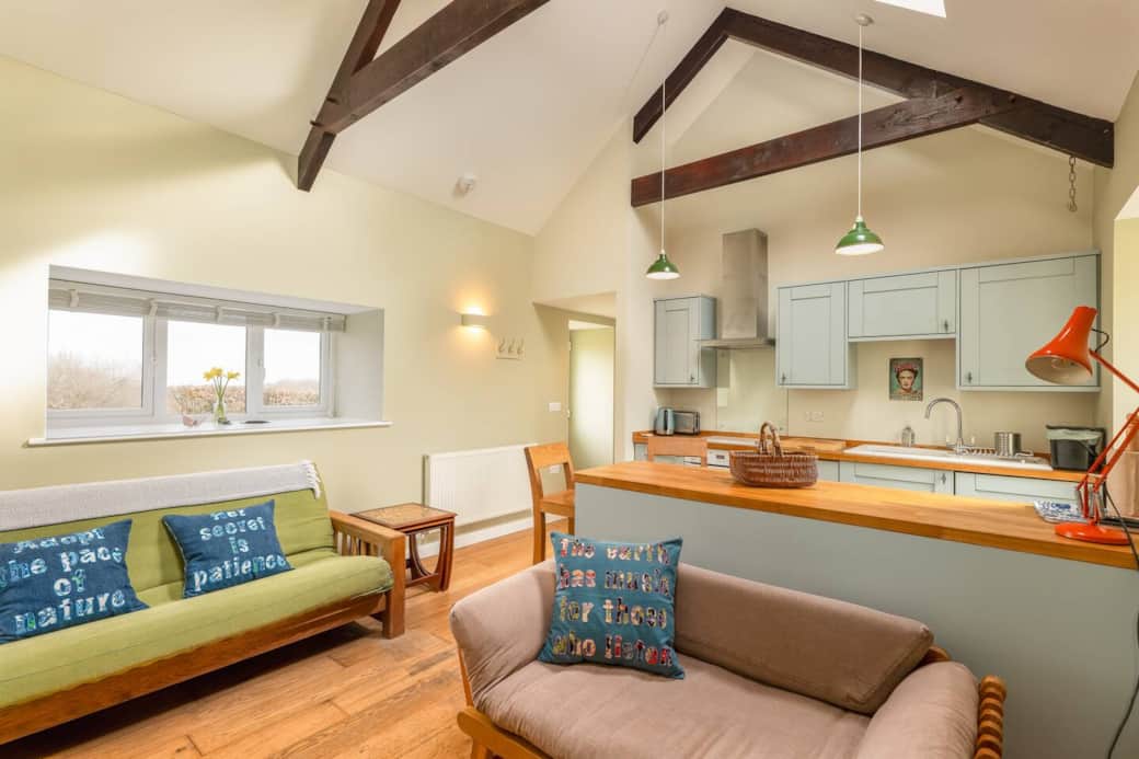 Living space and kitchen 
Breakfast Bar 
Double height ceilings with exposed beams.
3 seater sofa (that can become a double bed) and 2 seater sofa (that can become a single bed or a chaise) Bedding is always available for these sofa beds.