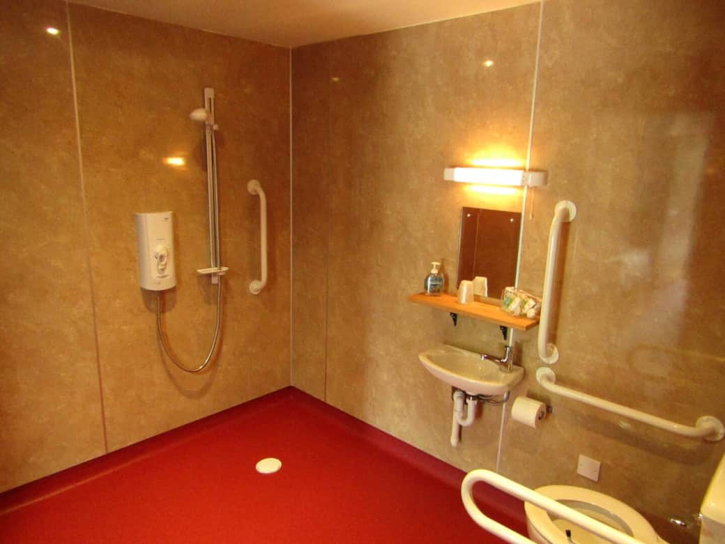 Shower with grab rail, shower chair also available