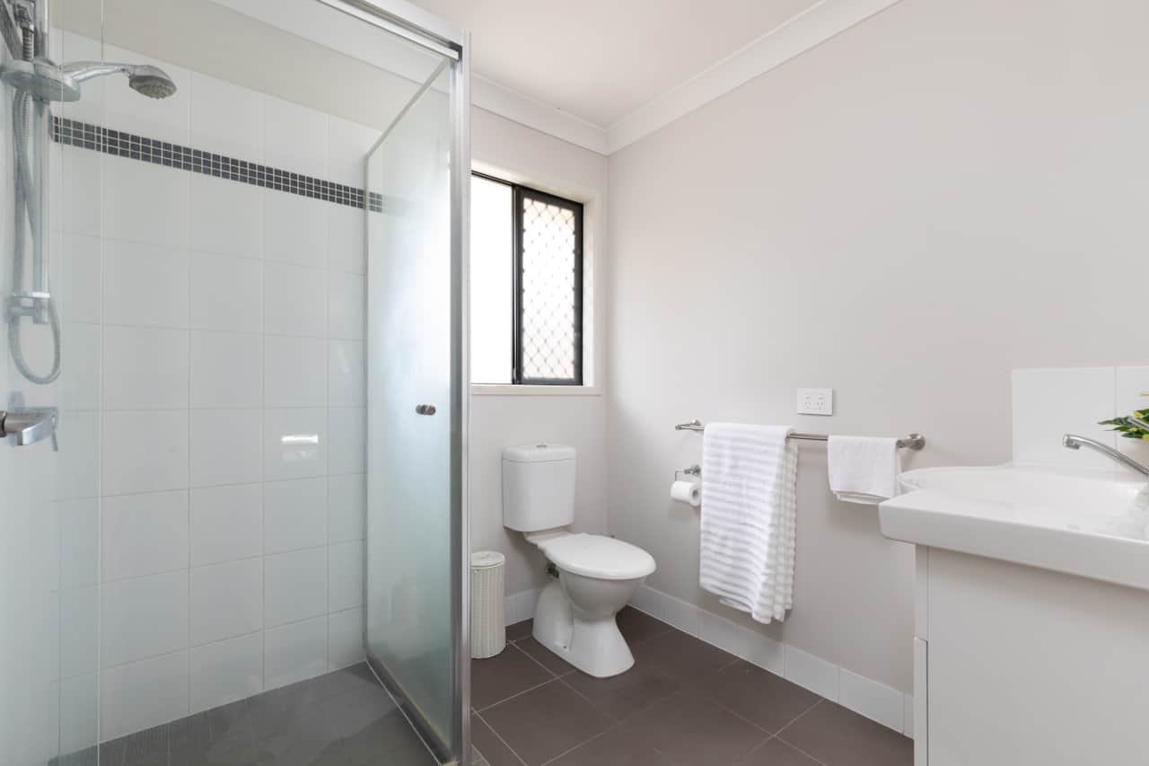 Bathroom: Stylish bathroom with walk-in shower, vanity, and clean finishes