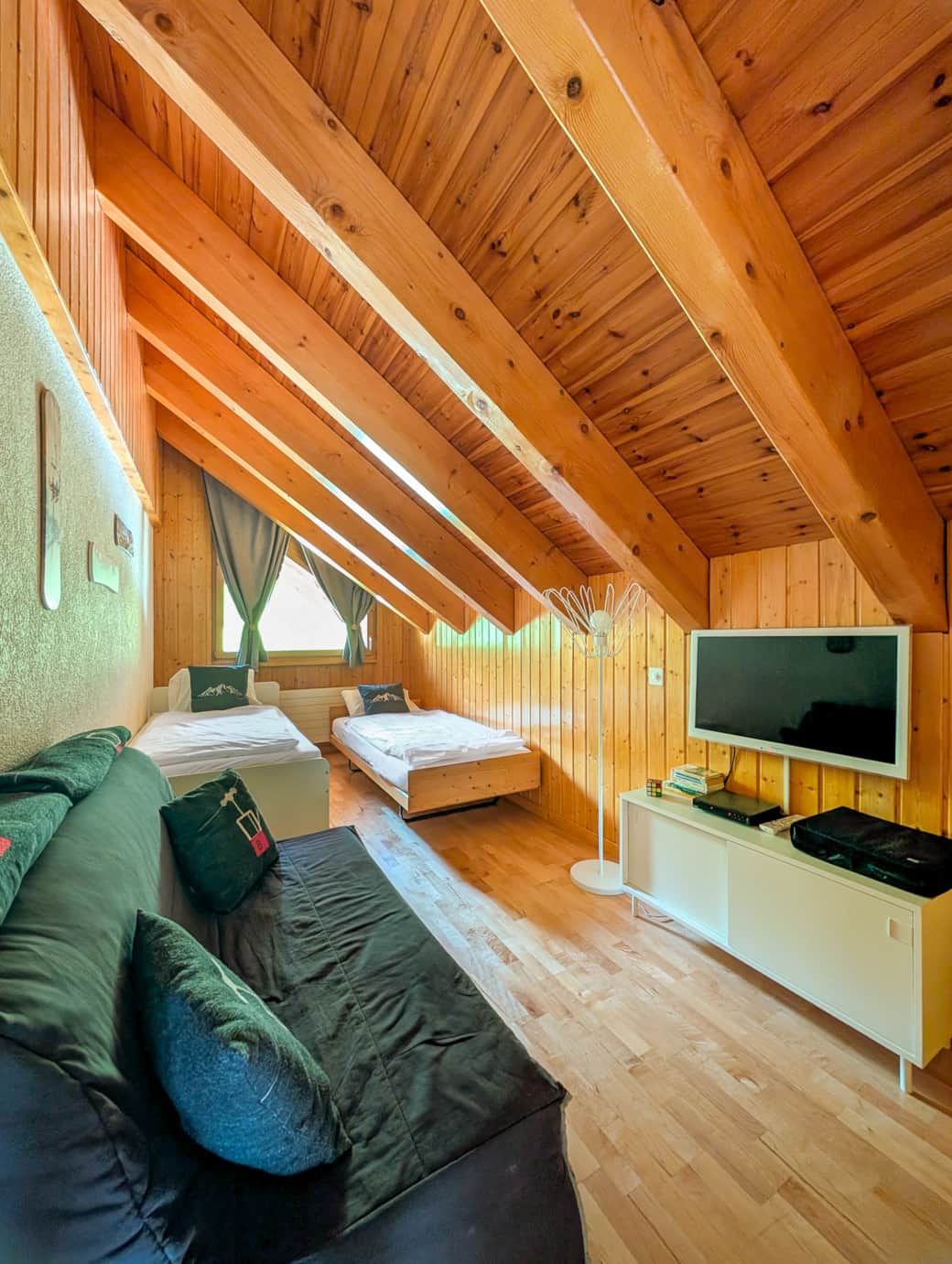 Chambre avec deux lit simple, canapé et TV