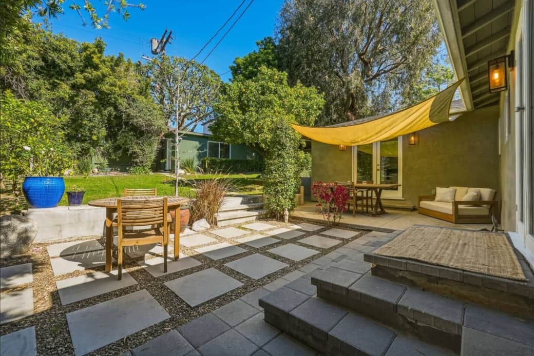 The patio provides extra seating with this two-seat outdoor sofa, creating a comfortable spot to relax and enjoy the backyard. The patio provides extra seating with this two-seat outdoor sofa, creating a comfortable spot to relax and enjoy the backyard.