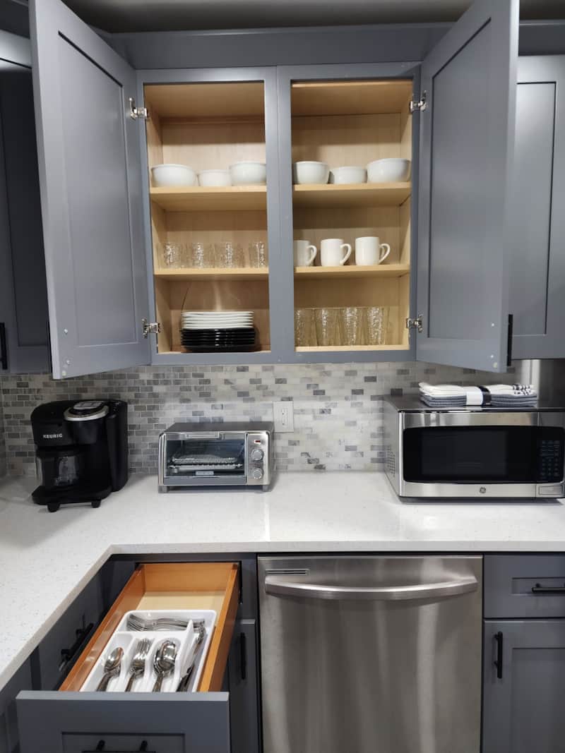 Kitchen equipped with dishware, utensils and small appliances