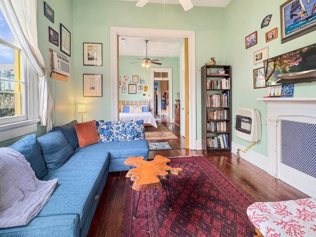 Living room couch converts into queen sleeper. With a stocked library, smart TV, and multiple climate options. 