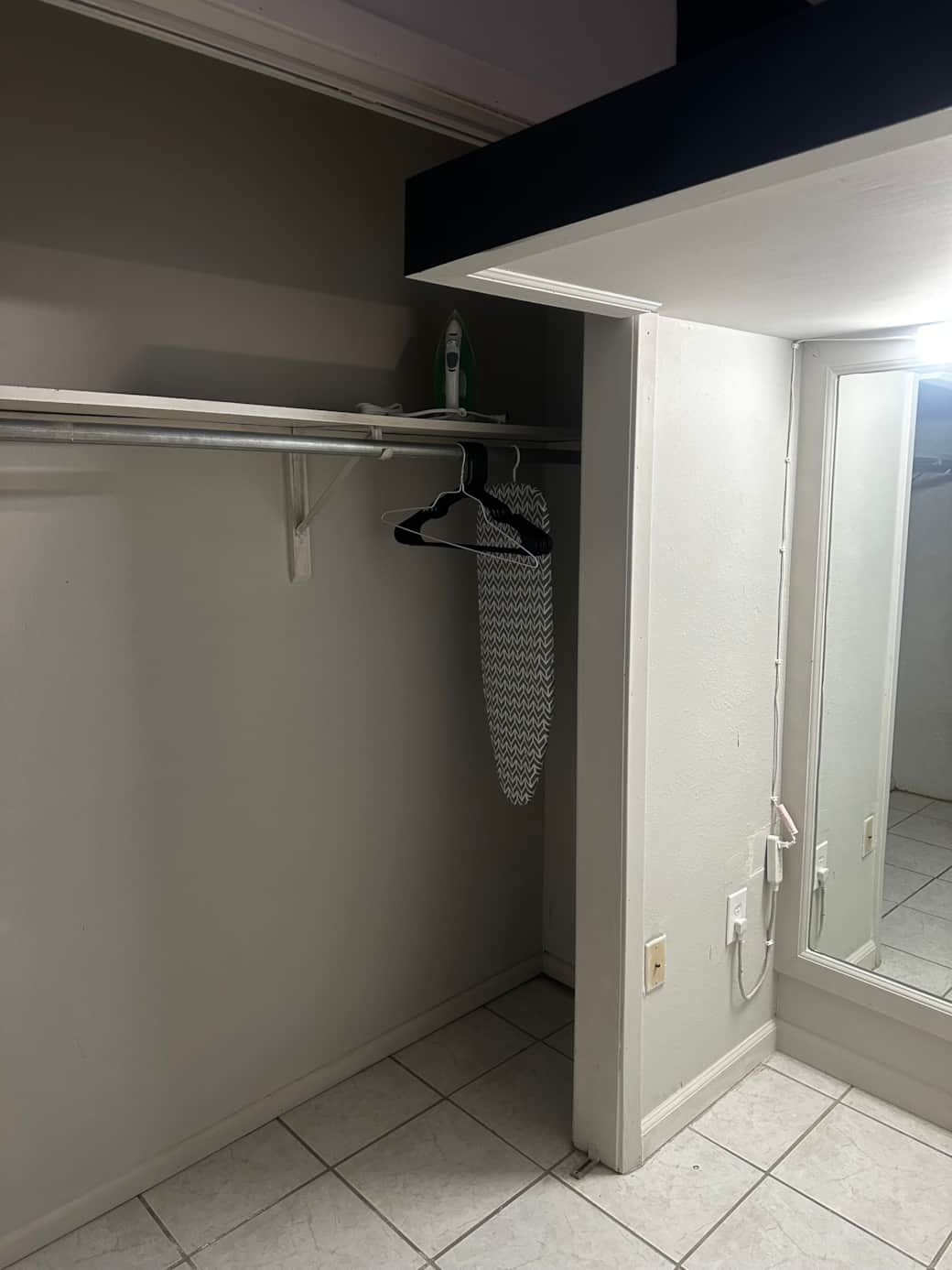 big mirror behind the bed next to the closet