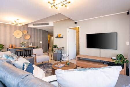A stylish and spacious living room with modern furnishings and abundant natural light. A stylish and spacious living room with modern furnishings and abundant natural light.