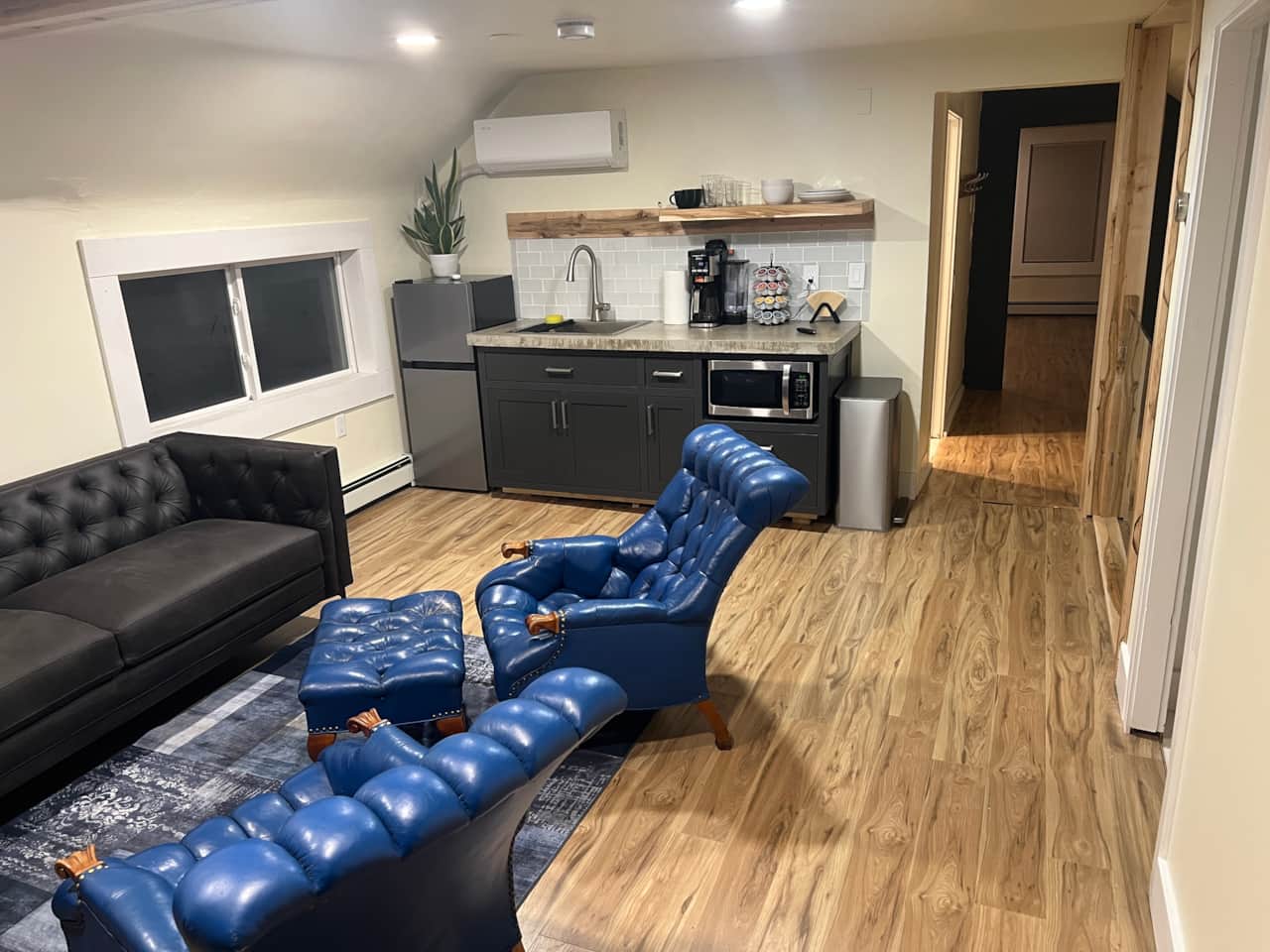 Living area includes a small kitchenette with Refrigerator and microwave, along w/ drip/kcup coffee.