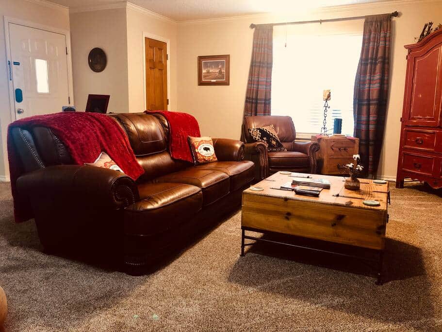Living area with leather couch and recliners. Living area with leather couch and recliners.
