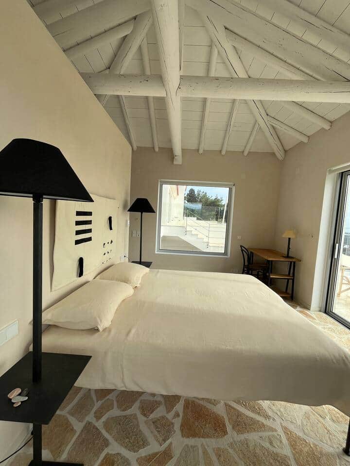 Elegant, minimalist sleeping area with natural materials and a calming atmosphere. This view highlights the west-facing window, welcoming soft morning light that gently fills the room and sets a serene tone for slow, sunlit awakenings.