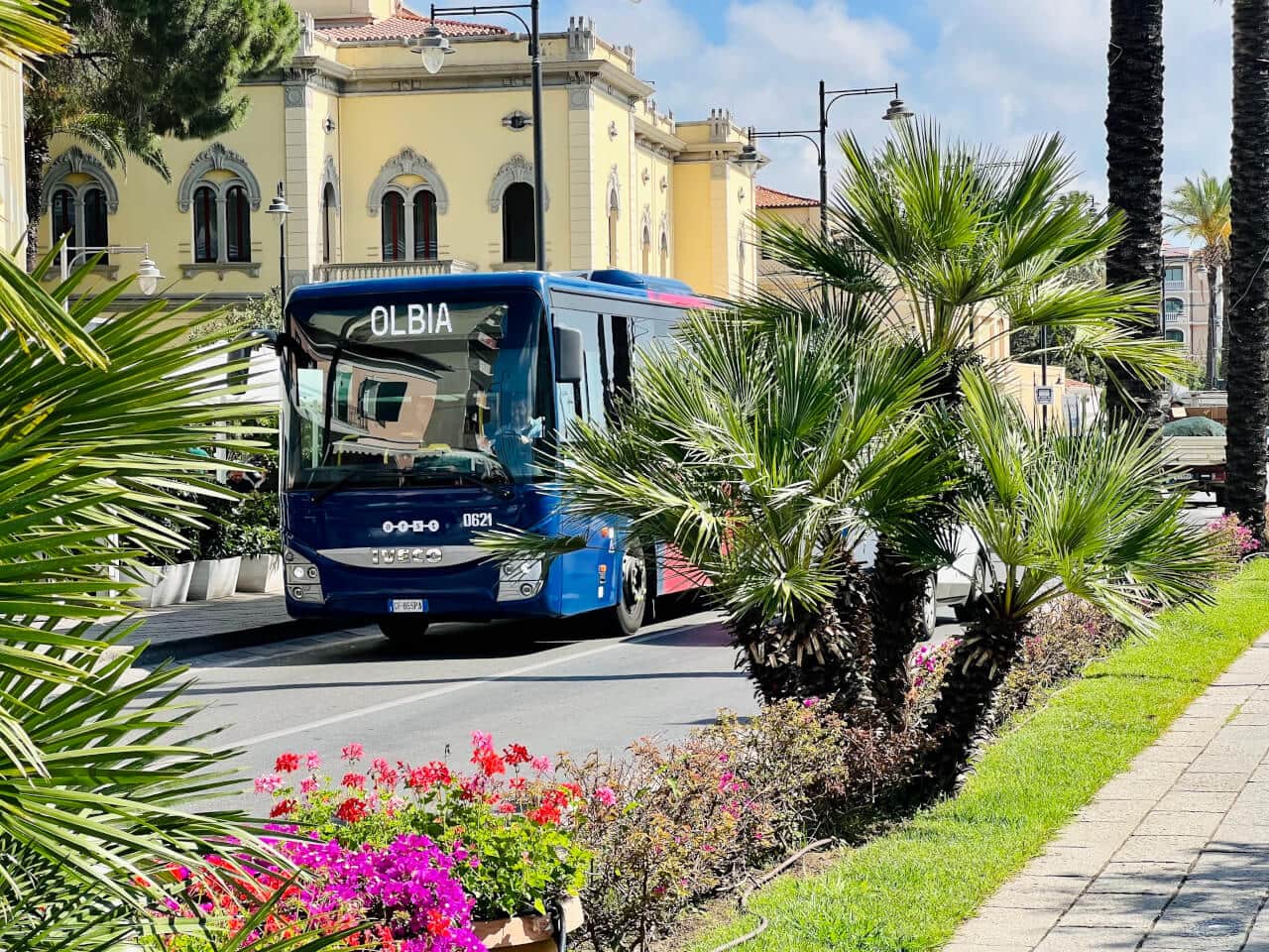 Olbia Old Town at sunset — narrow cobblestone street with warm Sardinian architecture and dramatic sky. Photo by RENTAL12.