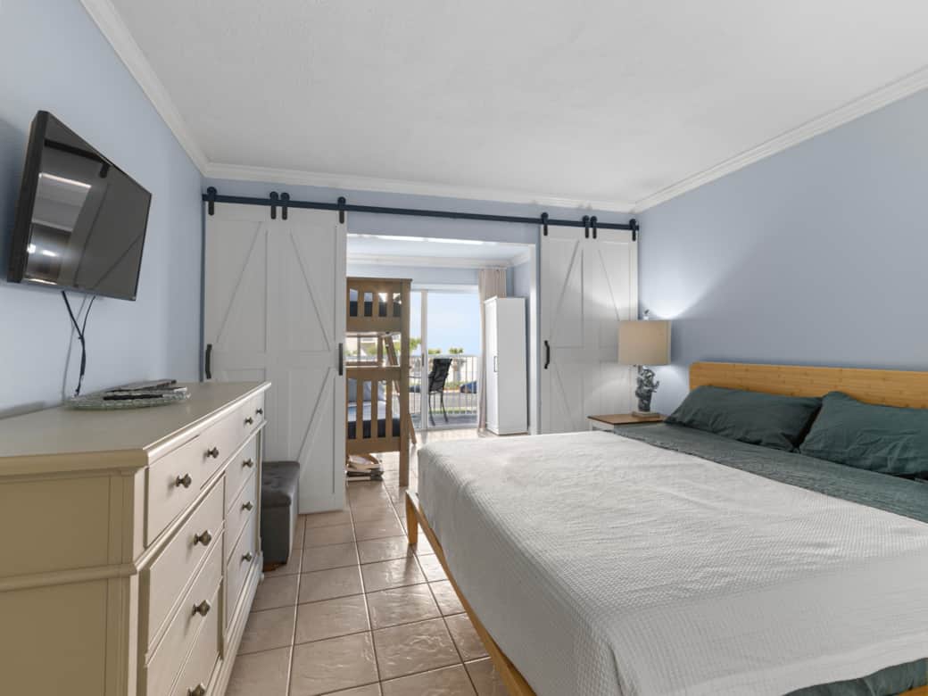 Primary bedroom with king bed and European linen sheets