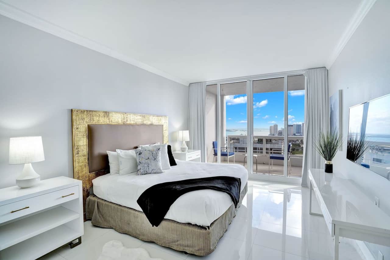 Master bedroom, king bed, tv, walk in closet, balcony access, desk, master bathroom