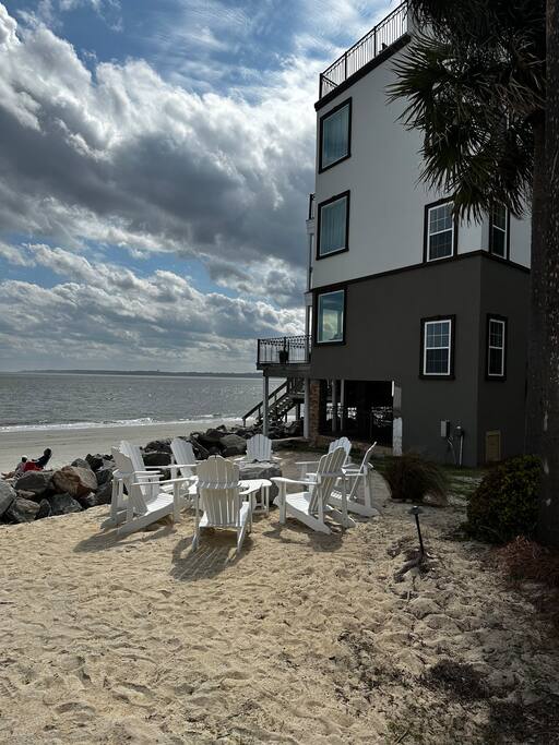 View of villa with private beach and solo stove fire pit.