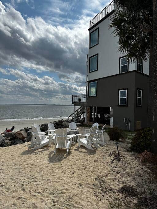 View of villa with private beach and solo stove fire pit.