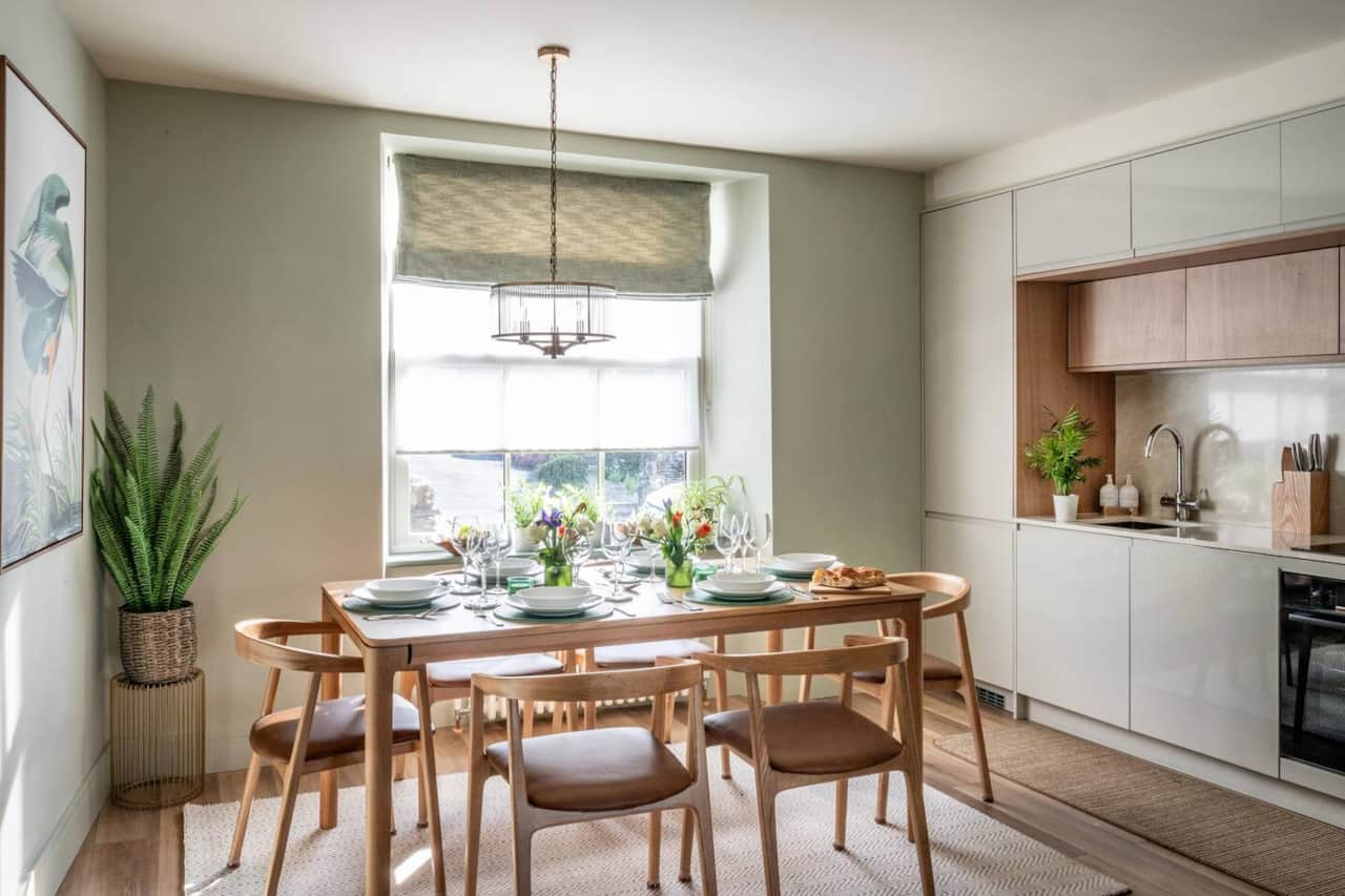 Dining area with extendable table to seat 10. comfortable leather covered chairs, with natural light.
