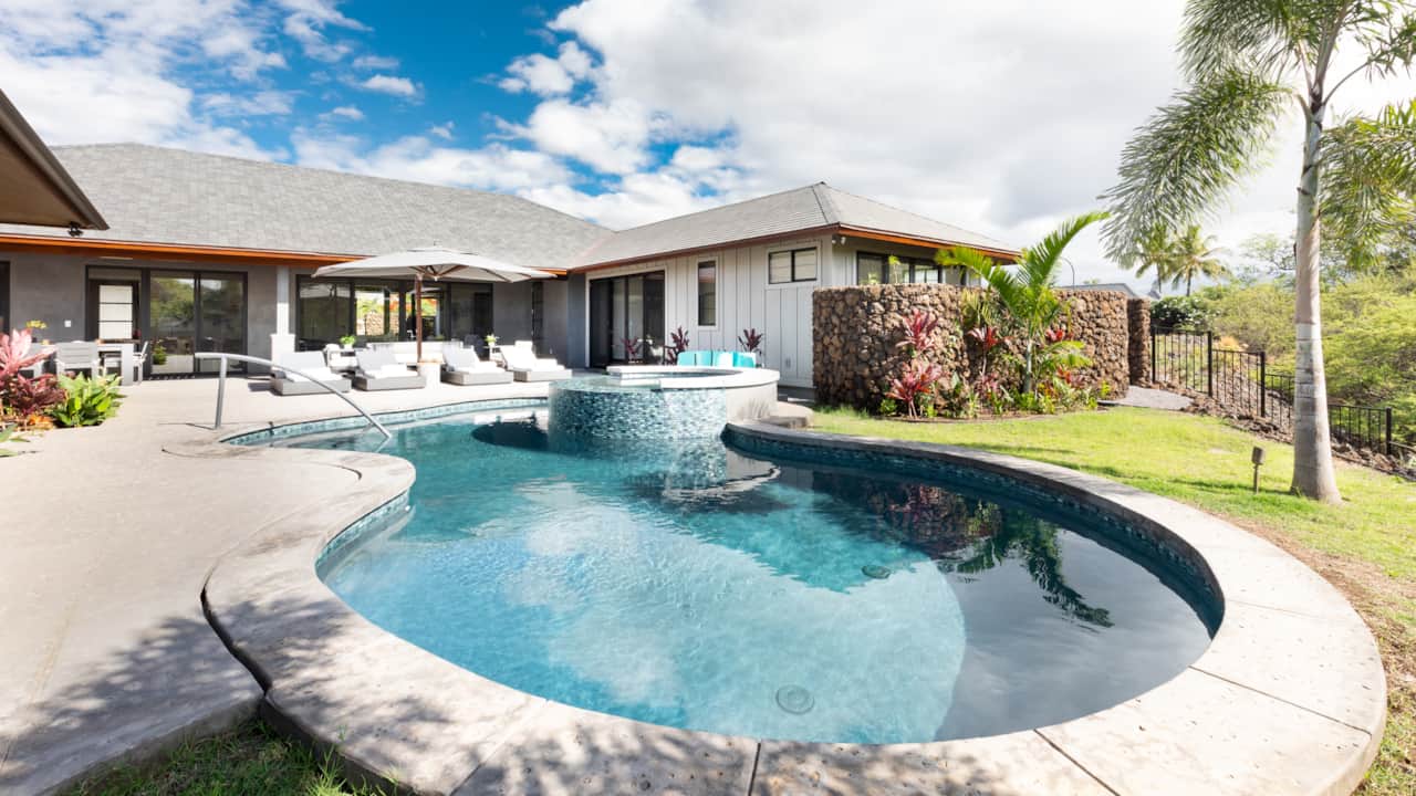 Enjoy your time sunbathing in the backyard with the private pool, spa, and loungers.