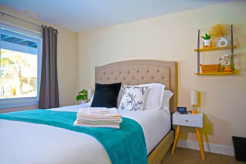 Cozy and comfortable bedroom with a plush queen-sized bed, fresh linens, and plenty of natural light. Includes a closet, bedside tables, charging stations and can’t forget the 65” TV to make you feel right at home.