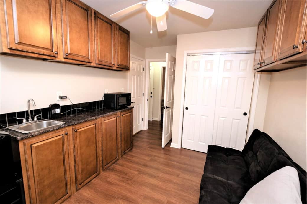 Furnished kitchenette with additional 12-place setting for a formal dinner or entertaining to be used with Alumni Apt 1 or 2. Furnished kitchenette with additional 12-place setting for a formal dinner or entertaining to be used with Alumni Apt 1 or 2.