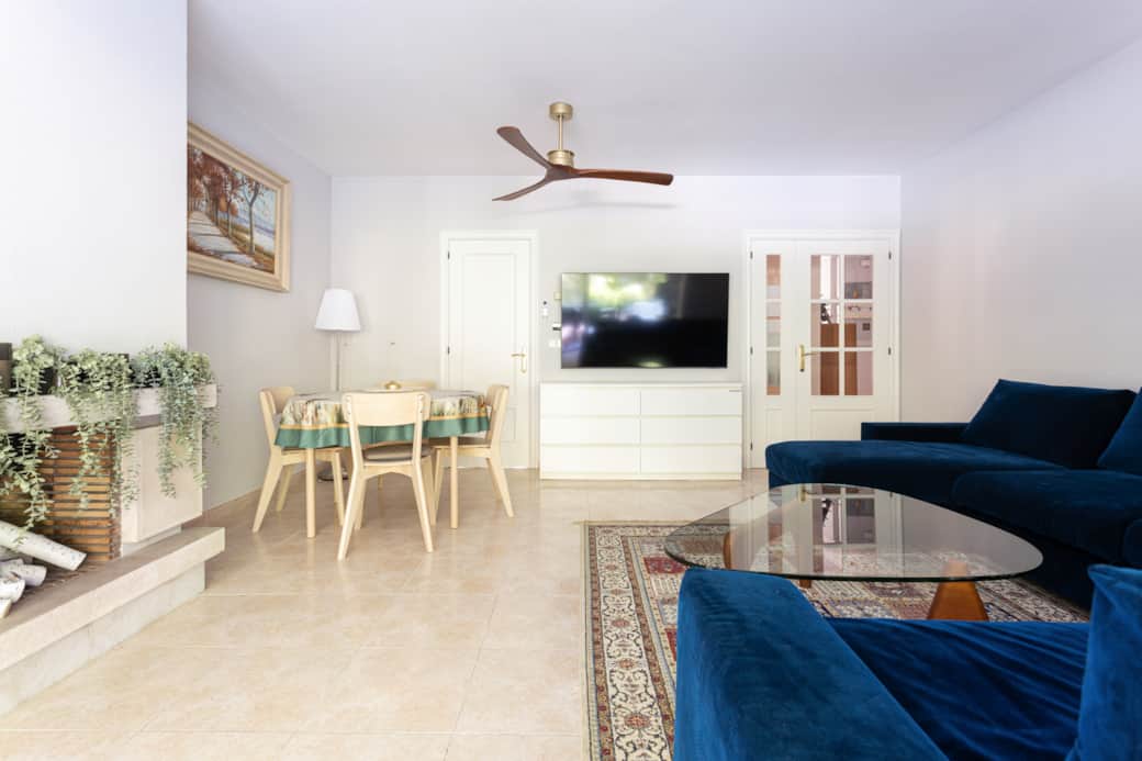 Spacious living room with 6-seat sofa, sofa bed, and dining for 8