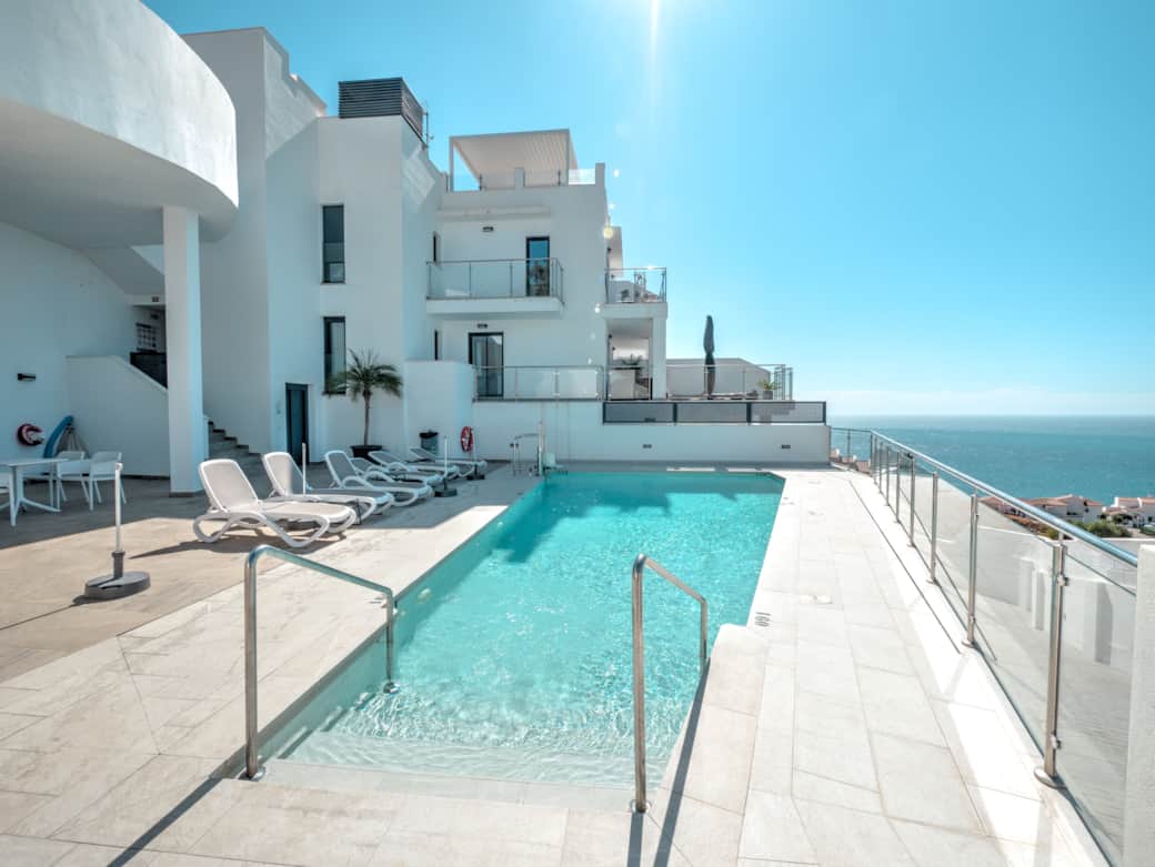 Communal pool with stunning sea views and sun loungers. Communal pool with stunning sea views and sun loungers.