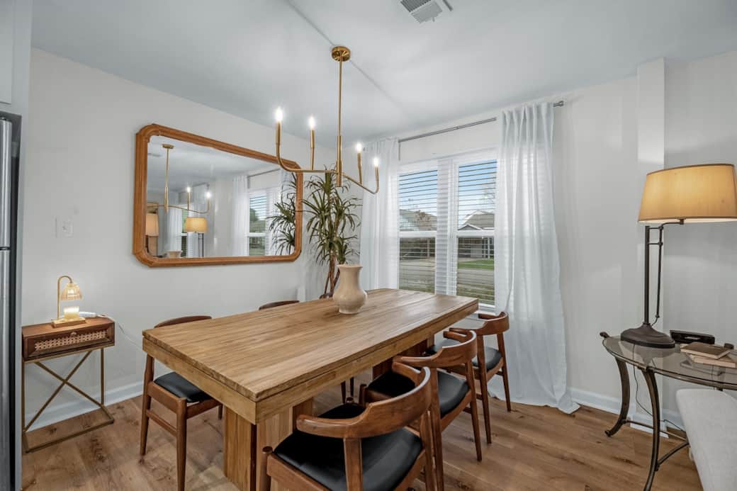 The open-concept layout connects the living room, dining area, and kitchen for easy gathering and conversation. Enjoy meals, morning coffee, or remote work at the dining table in a space designed for both comfort and functionality.