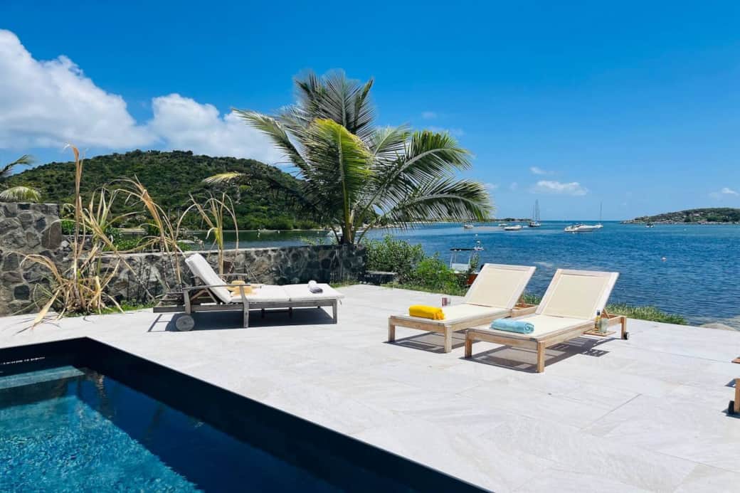 Swimming pool with deck chairs and sea view Chez Martine