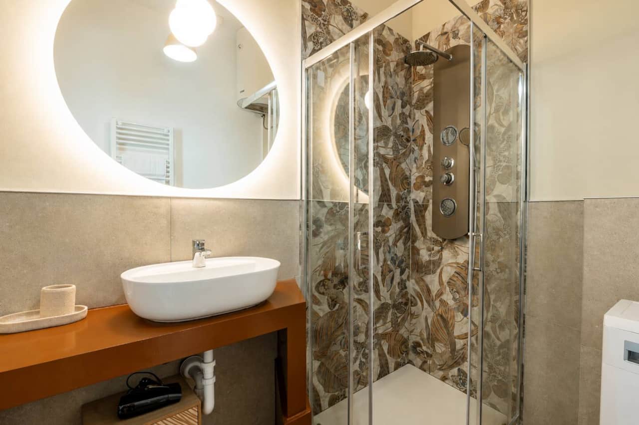 Bagno moderno con ampia doccia multifunzione e lavabo