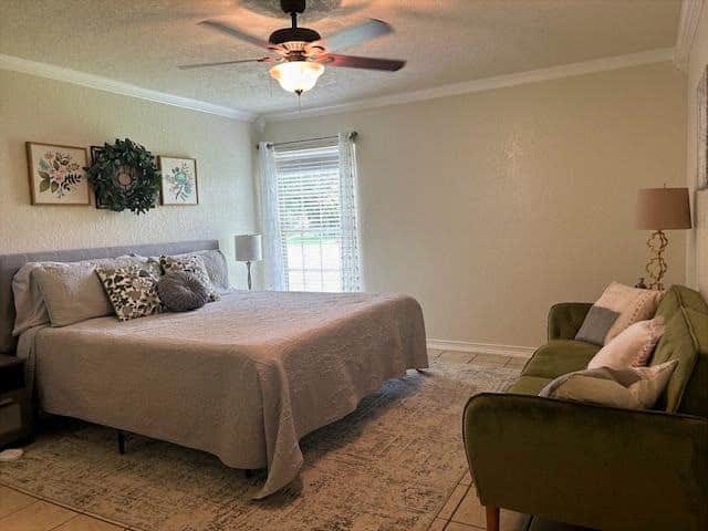 Primary  bedroom with king bed and attached bathroom with large walk-in closet. 