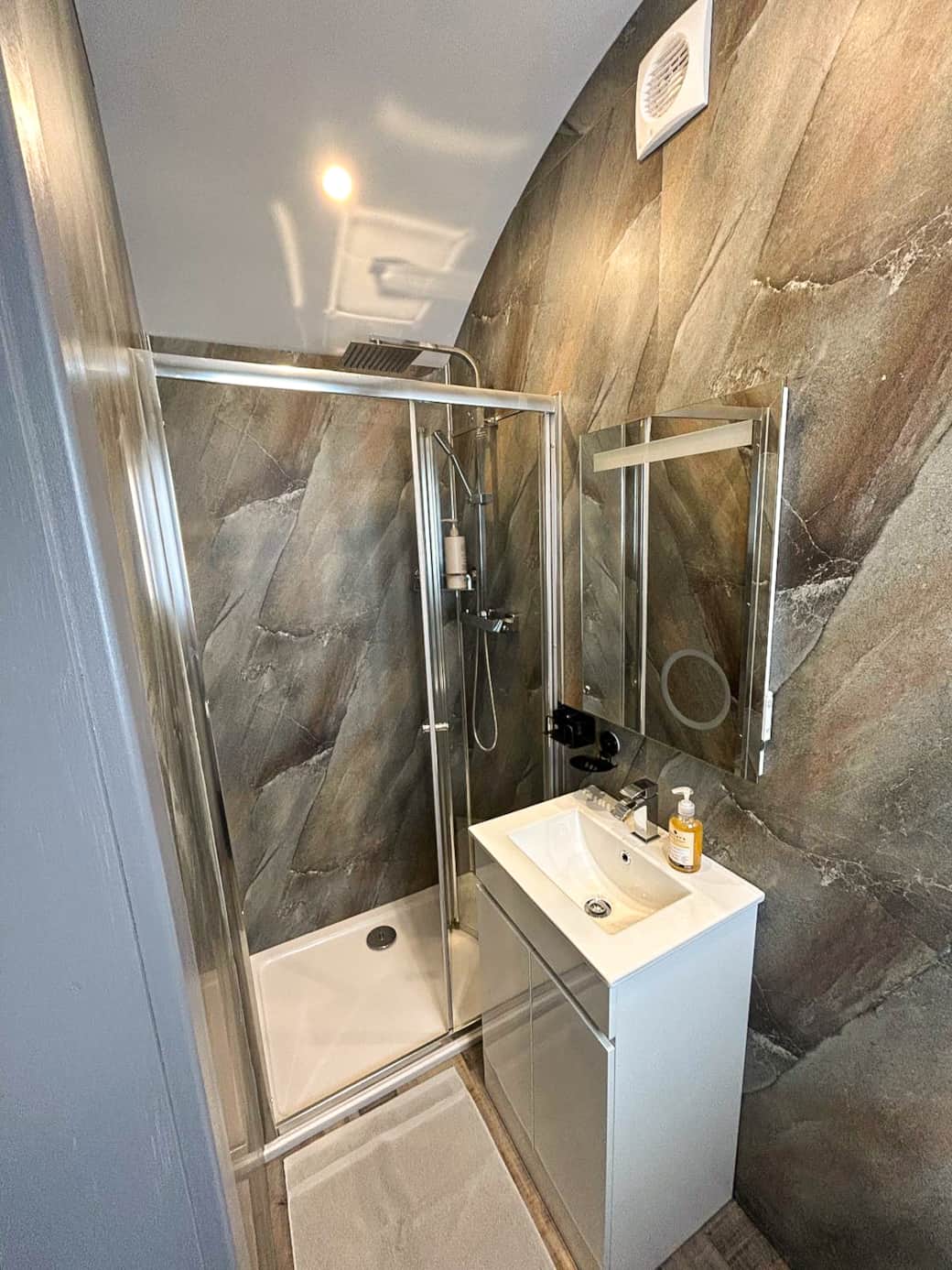 ChatGPT said:  Modern ensuite bathroom with walk-in shower and contemporary finishes.