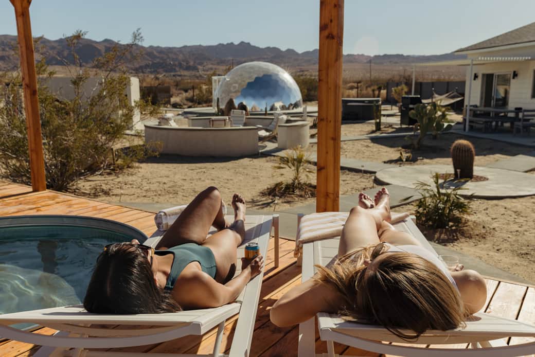 Sunbathing on the deck, overlooking the dome and the profound stillness of the Mojave expanse.