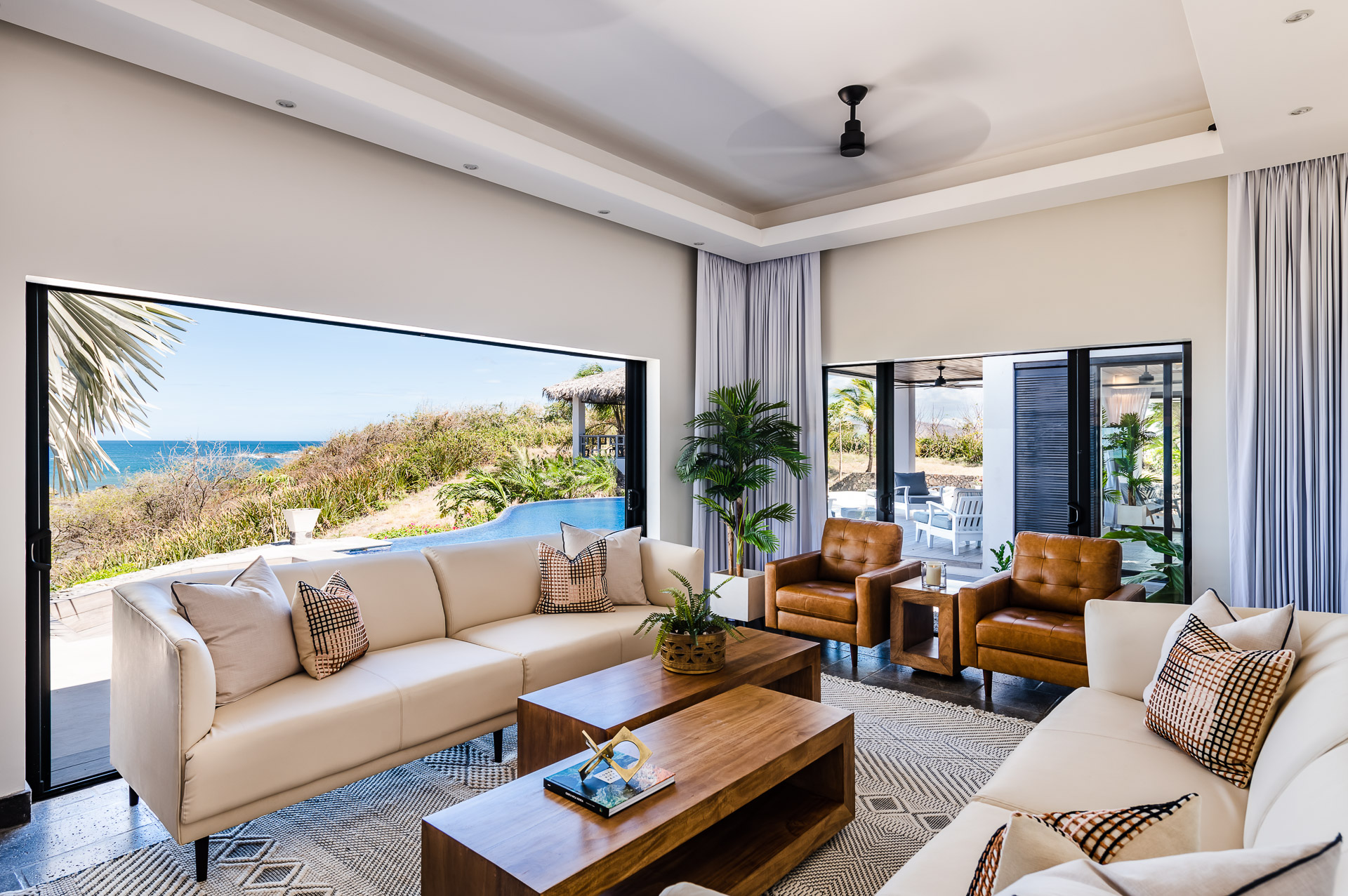 Custom made leather sofas, double sitting chairs and a 60” Television.