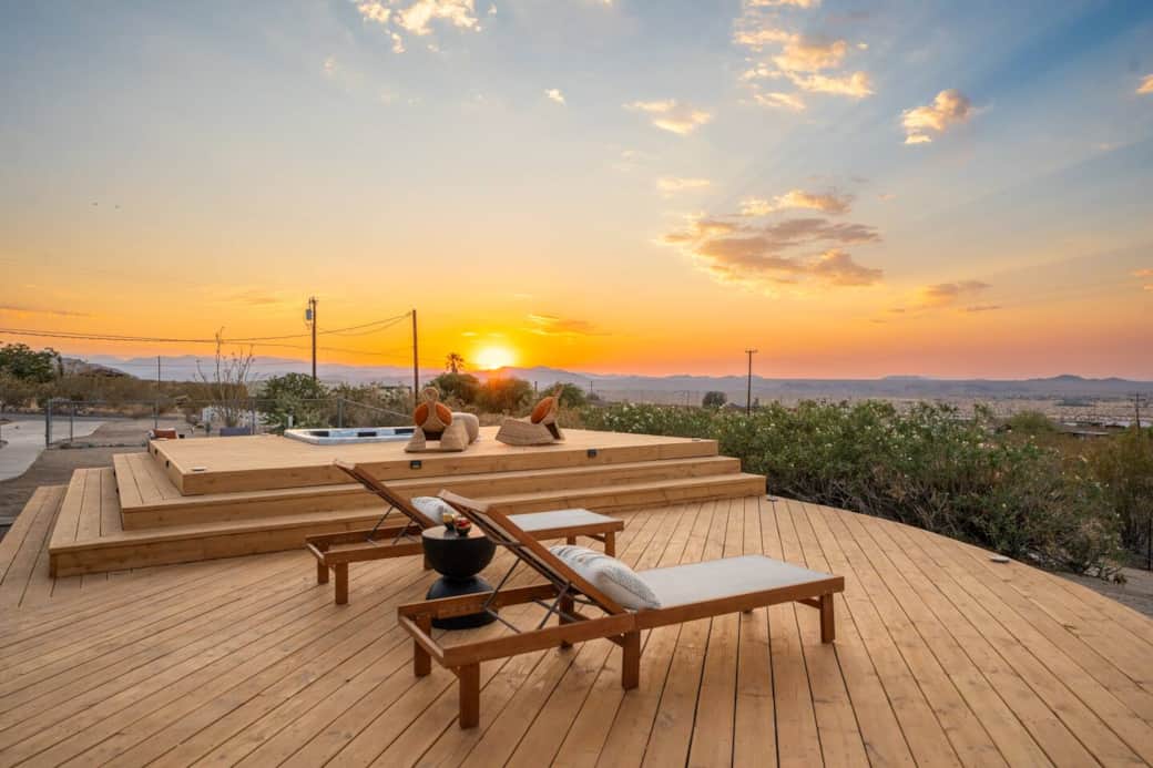 Relax on the lounge chair while immersing yourself with the sunset and the city view